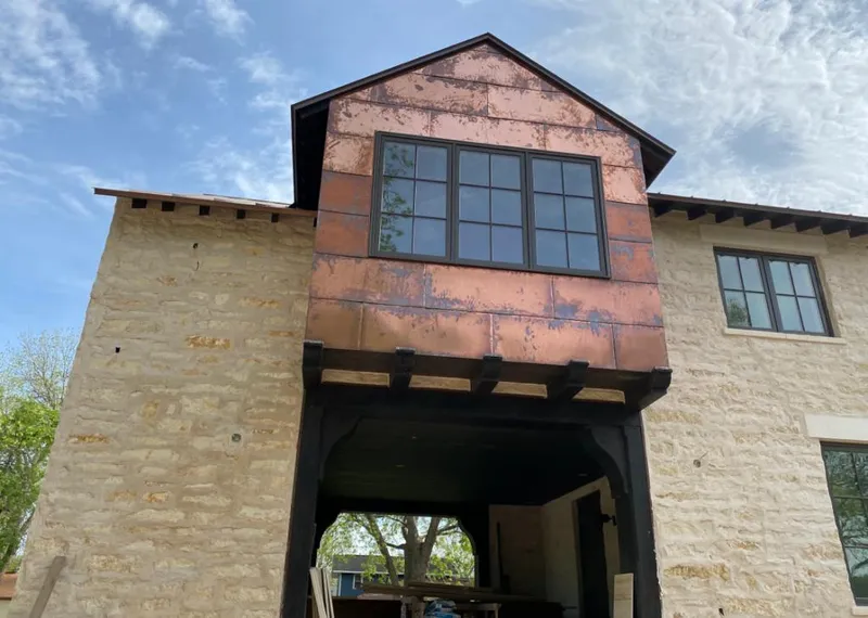 Copper metal panel facade on a stone building for Skylight Installation in Burleson